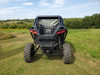 Wide rear view of a black Polaris RZR Pro XP in a field with the 3 Star soft back panel installed