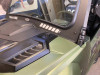 Front three-quarter view of the Extreme Metal Products windshield frame and vents over the green Wolverine hood