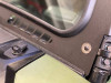 Close-up of the Extreme Metal Products windshield frame corner showing the hinge bracket and vent slots