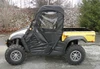 3 Star half-door cab enclosure with top and rear window on a yellow Cub Cadet Challenger, side view on gravel