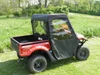 3 Star full cab enclosure installed on a red Kymco 700i, rear three-quarter view in a grassy field