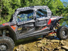 3 Star black soft upper doors with clear windows on a red and black Polaris RZR XP 4 1000, close side view by a creek