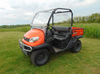 3 Star Lexan rear window installed on an orange Kubota RTV X900/X1120D, front three-quarter view