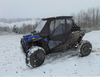 Blue Polaris RZR XP Turbo S with the 3 Star full cab enclosure installed, front three-quarter view in snow