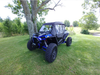 Passenger side three-quarter view of a blue Polaris RZR XP Turbo S with the 3 Star full cab enclosure