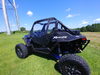 Side rear view of a blue Polaris RZR XP Turbo S showing the 3 Star soft door and support bars