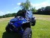 Front three-quarter view of a blue Polaris RZR XP Turbo S with the 3 Star soft upper doors in summer grass