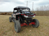 Rear three-quarter view of a RZR XP 4 Turbo S with the 3 Star soft top installed, whip flags and bare roll cage behind