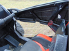Inside view of a 3 Star lower door insert on a RZR XP 4 Turbo S, black panel below the door frame beside the red seat