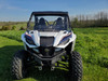 3 Star black soft top on a white Wolverine RMAX2, straight front view in a sunny green field