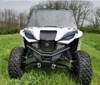 Straight front view of a white Wolverine RMAX2/4 with the 3 Star one-piece windshield installed, winch bumper in front