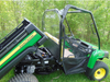 Side view with the dump bed raised showing the 3 Star Lexan back panel edge and cab of the John Deere Gator XUV