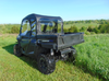 Rear three-quarter view of a blue Arctic Cat Stampede with the 3 Star full cab enclosure and rear window