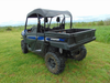 3 Star soft top for hard windshield on a blue Arctic Cat Stampede, rear three-quarter view in a field