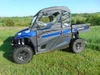 3 Star soft doors with clear windows on a blue Arctic Cat Stampede, driver side profile in a grassy field