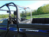 Driver side view of the 3 Star soft rear window behind the cage of a black Arctic Cat Stampede