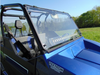 Driver side close view of the 3 Star scratch-resistant windshield with vent row on an Arctic Cat Stampede
