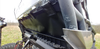 Angled close-up of the 3 Star rear window edge and black lower back panel where it meets the Can-Am Commander cage tube