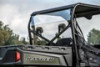 Kolpin rear window on a gray Polaris Ranger seen from the rear with trees in the background