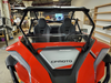 Front view of the 3 Star clear half windshield installed on a red CF Moto ZForce inside a shop
