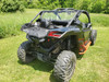 Rear three-quarter view of a black Can-Am Maverick X3 with the 3 Star soft back panel installed in grass