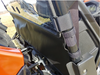 Close-up of a black vinyl panel edge strapped to the roll cage of an orange CF Moto UForce