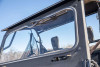 Kolpin manual wiper blade mounted on the windshield of a side-by-side cab, seen from outside