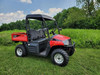 3 Star black soft top installed on a red Coleman UT400, front three-quarter view in a green field