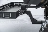 Kolpin 2-inch receiver hitch cargo carrier close-up showing the black steel tray and angled hitch tube in snow