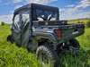 Rear three-quarter view of a blue Polaris Ranger 1000 Crew with the 3 Star cab enclosure rear window