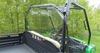 Angled view from the bed of the 3 Star Lexan back panel behind the seats of a green John Deere Gator