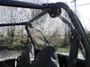 View from inside the cab of the 3 Star Lexan back panel and its cage clamp behind the Polaris RZR 900 seat