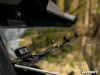 Close-up of the SuperATV windshield hinge bracket and clear panel edge on the Gator XUV835