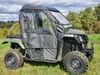 Side profile of the 3 Star full cab enclosure doors with clear vinyl windows on a green Honda Pioneer 500