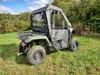 Passenger side rear three-quarter view of the 3 Star full cab enclosure on a green Honda Pioneer 500 in a field