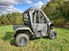 Closer rear three-quarter view of the 3 Star cab enclosure doors and rear window on a green Honda Pioneer 500