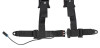 Lower section of the black Pro Armor harness laid flat showing the lap belts, buckle and sensor wire