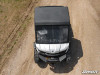 SuperATV aluminum roof on a white Can-Am Defender HD10 seen from above the hood on a gravel road