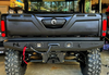 Rear view of the No Limit rear winch bumper on a Can-Am Defender in a shop, showing light cutouts and hook