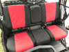 Greene Mountain red and black seat covers installed on the rear bench seat of a Can-Am Defender MAX Limited, side view
