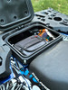Highlands cargo box open on the Polaris Sportsman rear rack with a tool pouch and gloves stored inside