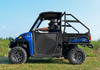 Full side view of the blue Polaris Ranger XP with SuperATV aluminum doors and a driver seated, in a field