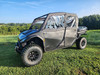 Front three-quarter view of the 3 Star upper doors with clear windows on a black Segway UT10 Crew in a field