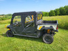 Side view of the 3 Star upper doors on a green Arctic Cat Prowler PRO Crew with cargo bed, parked on grass