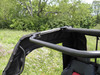Close-up of the 3 Star rear window edge strapped to the cage tube of a black side-by-side with red seats