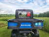 Straight rear view of the 3 Star soft rear window above the bed of a blue New Holland 850 Crew