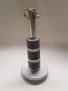 Eagle plow skid foot with hardware: round base, black rubber pads and lynch pin on a studio backdrop