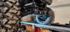 Narrow low-angle view under the CFMoto UForce U10 Pro on a lift showing the 3 Star skid plate edge by the A-arm