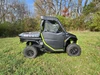 3 Star upper door and rear window combo on a black and green Segway UT10, driver side view in a field