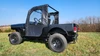 Driver side profile of the Mahindra Roxor with the 3 Star full soft doors and clear windows installed